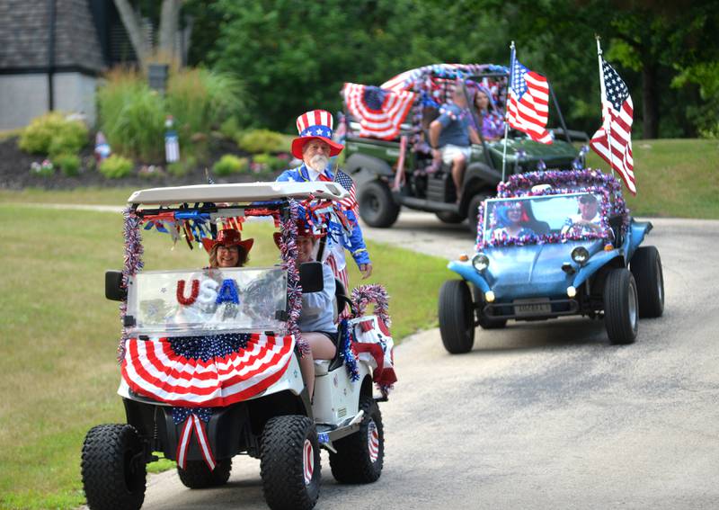 Jim Ross (Uncle Sam) and his wife, Connie (seated) led the 7th Annual Grand Detour Golf Cart Parade on Sunday, July 6.