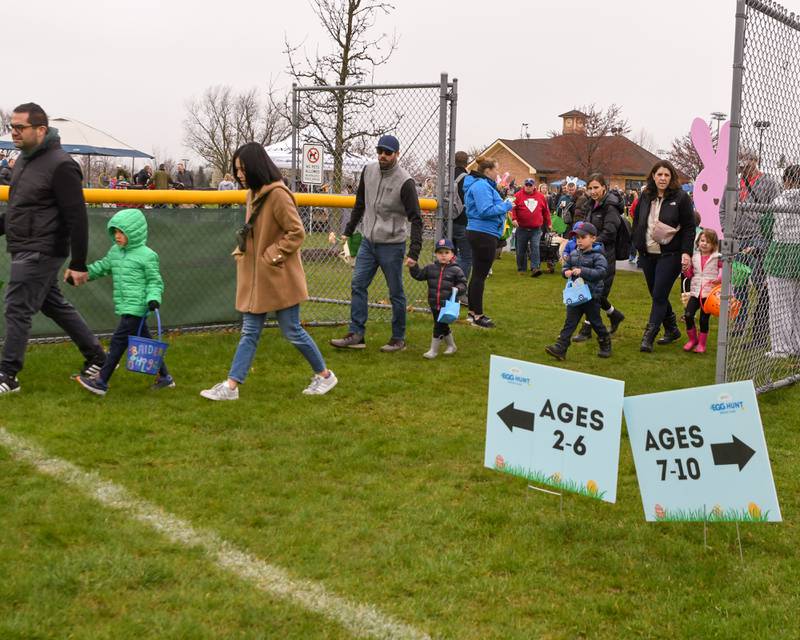 Participants line up against the fence line of one of three baseball fields by age range before the start of the Easter egg hung on Saturday April 18, 2025, held at Berens Park in Elmhurst.