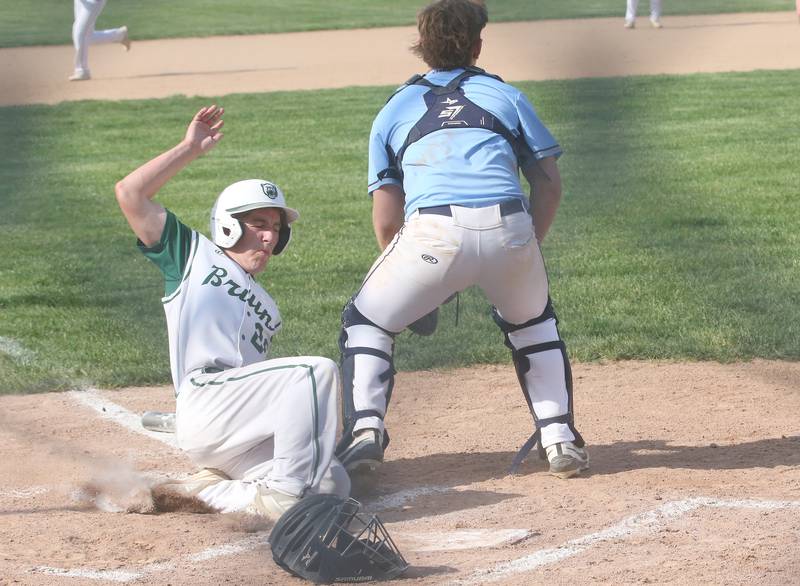 St. Bede's Ryan Soliman slides in safely across home plate to score the teams first run as Bureau Valley catcher Elijah Endress waits for the late throw on Wednesday, May 14, 2025 at St. Bede Academy.