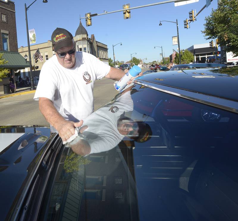 Jake Bauman shines up his Oldsmobile 442 during the Dream Machines Car Club’s Cruise Night  Saturday in Streator.