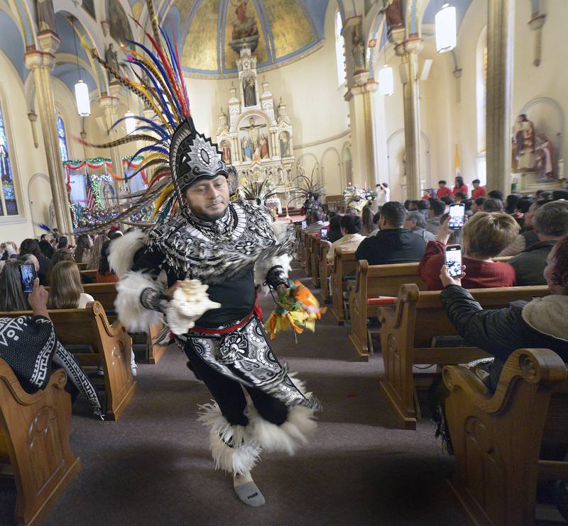 A member of Danza Chichimeca, of St Mary’s Parish in Bloomington, performs a ceremonial dance inside St. Michael’s Church, Streator, following Mass on Sunday, Dec. 8, 2024, celebrating the Feast of Our Lady of Guadalupe. The dancers were brought in to celebrate Mexican culture in tandem with the Guadalupe celebration, which commemorates the mass conversion of indigenous peoples to Christianity in the 16th century.