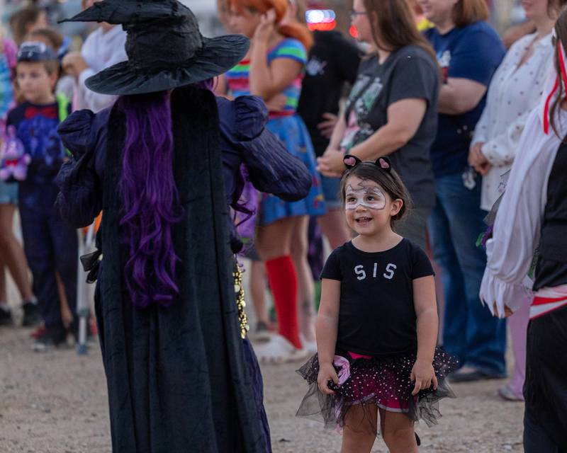 (from left) 'Hocus Pocus Hags' performer dances with Raya Bopes in front of crowd at the Monster Mash Balloon Bash on Saturday, Oct. 4, 2025 at the Bureau County Fairgrounds in Princeton.