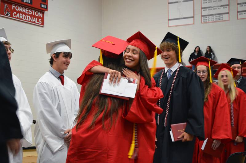 Lily Johnson, right, hugs Dixie Johnson as the Forreston High School Class of 2023's commencement nears its end on May 14, 2023. Lily plans to study biology at Highland Community College; Dixie plans to attend the University of Illinois Urbana-Champaign.