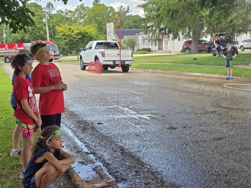 Children spectators watch and cheer Saturday, Aug. 3, 2024, during the Granville Days water fights at Hopkins Park.