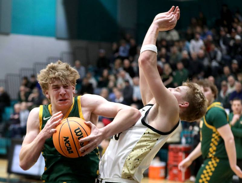 Crystal Lake South's Carson Trivellini elbows Sycamore's Isaiah Feuerbach as he grabs a rebound during an IHSA Class 3A Woodstock North Sectional semifinal.basketball game on Wednesday, March 4, 2025, at Woodstock North High School.