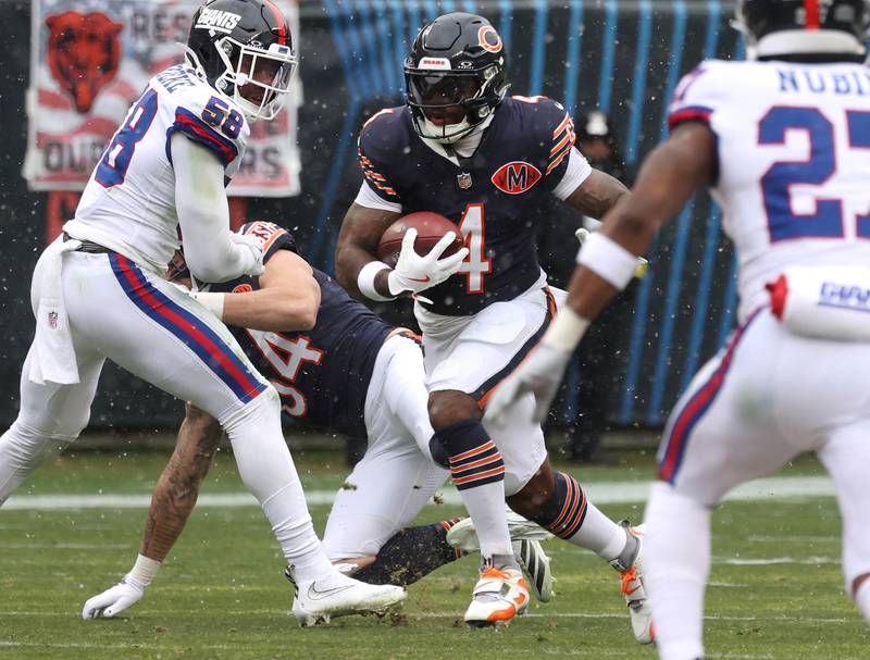 Chicago Bears running back D'Andre Swift goes by New York Giants linebacker Bobby Okereke Sunday, Nov. 9, 2025, during their game at Soldier Field in Chicago.