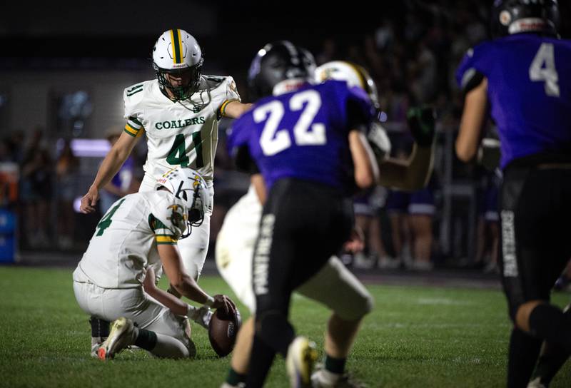 Coal City's Mason Hamilton kicks an extra point as Carter Gill holds the ball in a game against Manteno on Friday, October 3, 2025.