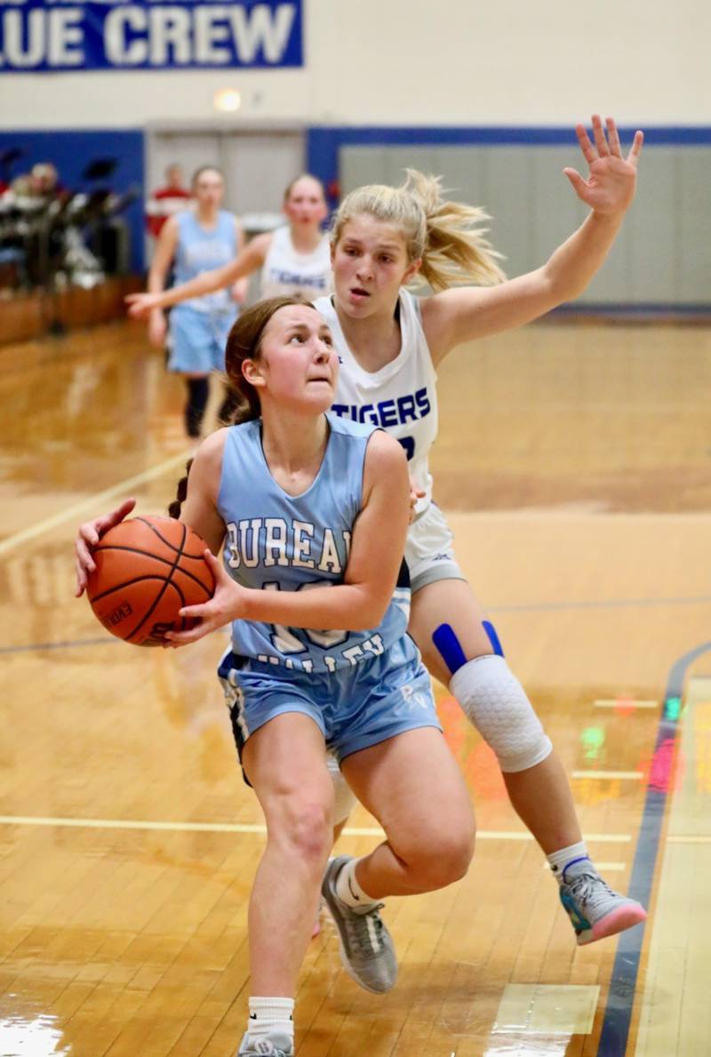 Bureau Valley freshmen Libby Endress gets past Princeton's Reese Reviglio for a layup in the second half of Monday's game at Prouty Gym. Endress scored 15 points to lead the Storm to a 55-45 win.