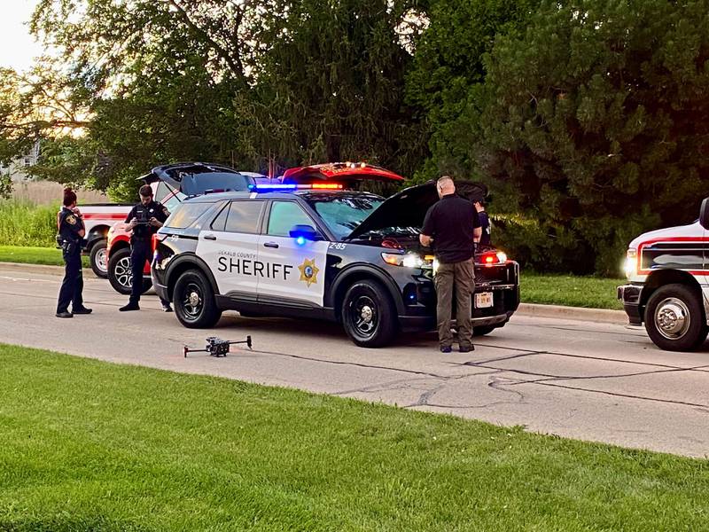 DeKalb County sheriff's deputies prepare an aerial drone to deploy to assist a water rescue on Sunday, July 27, 2025, in the 600 block of Ridge Drive in DeKalb.
