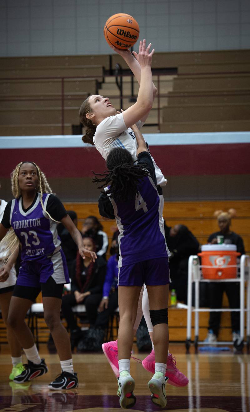 Kankakee's Ava Johnson elevates for a shot over Thornton's Shaniyah Blackmond in a game on Thursday, December 4, 2025.