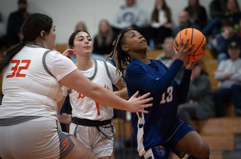 Grace Christian's Zoey Baldridge, right, elevates for a lay-up as Beecher's Molly Vladika, left, and Madison Smith, back left, guard in a game on Monday, January 5, 2026.