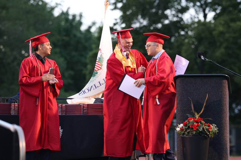 Student speakers Calvin Kohl, center, and Jostin Ramirez, left, congratulate classmate Derek Otero on his speech during the Bradley-Bourbonnais Community High School commencement ceremony on Thursday, May 21, 2026.