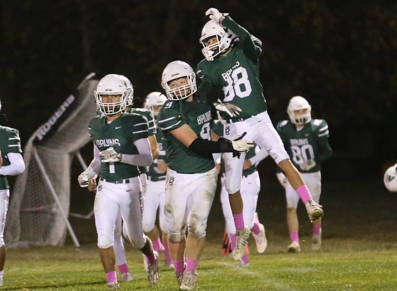 St. Bede's Jack Maschmann and teammate Max Moreno leap in the air while celebrating a victory over Ottawa on Friday, Oct. 25, 2024 at St. Bede Academy.