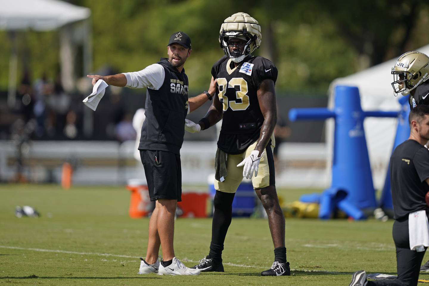 New Orleans Saints tight end Juwan Johnson (83) runs through drills with offensive assistant Declan Doyle during training camp at their NFL football training facility in Metairie, La., Thursday, Aug. 4, 2022. (AP Photo/Gerald Herbert)