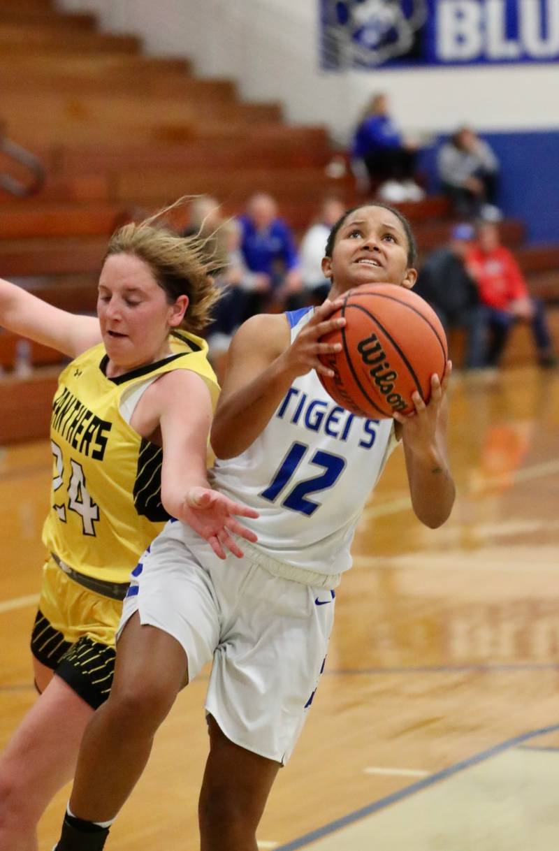 Princeton's Mariah Hobson slips past Gracie Cuicci of Putnam County in tournament play at Princeton Monday. The Tigresses won 62-36.