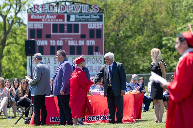 Graduate shakes hand of Administrator on Sunday, May 18, 2025 at Hall High School in Spring Valley.