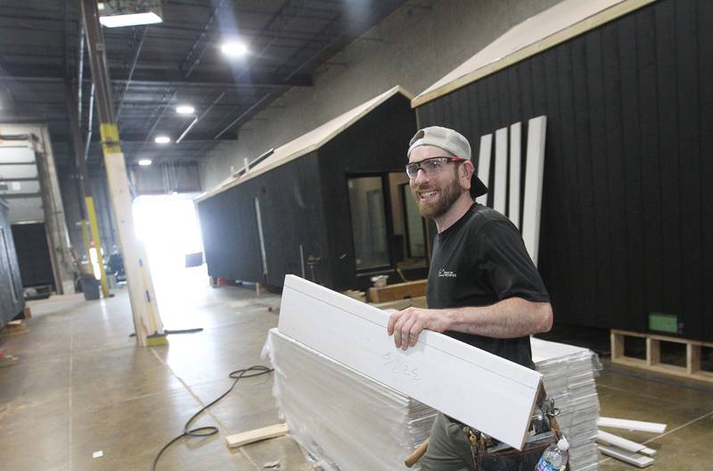 Lead carpenter Joseph Luszcz, of Palatine, works on pocket door trim for a Milla Long, a prefabricated tiny home with 456 square feet, in the factory at PrefabPads LLC in Waukegan on July 17, 2023.