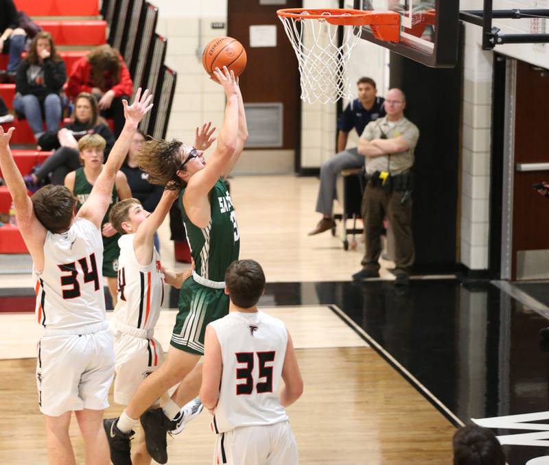 St. Bede's Landon Jackson (13) scores on a drive to the hoop past Flanagan-Cornell defenders during the Route 17 Thanksgiving Classic on Tuesday, Nov. 22, 2022, in rural Streator.