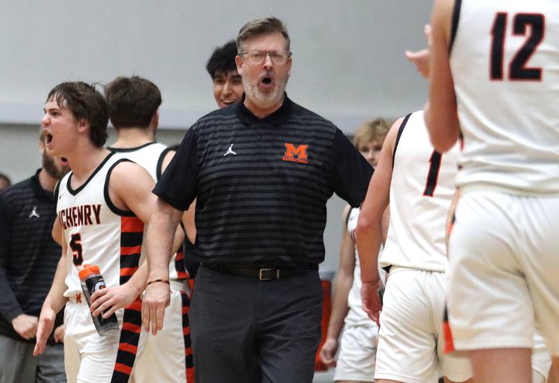 McHenry’s Head Coach Corky Card and the Warriors get revved up as they build a large first-half lead against Burlington Central in varsity boys basketball on Tuesday, Feb. 4, 2025, at  McHenry High School  in McHenry.