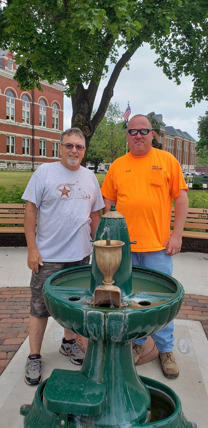 Mike Bowers (left) and Scott Wallace stand by Iron Mike, Oregon's historic free-flowing water fountain, which was recently repaired.