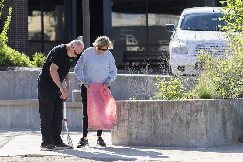 Dale Baker and Laurie McBride work together to give Dixon a spit shine Wednesday, May 1, 2024. Volunteers met in the morning to head out and pick up garbage for the start of the Beautify Dixon campaign.