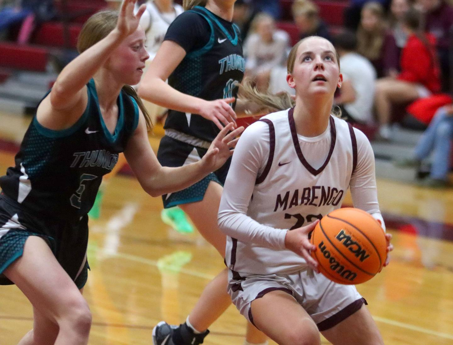 Marengo’s Sophie Hanson works under the hoop against  Woodstock North in varsity girls basketball on Tuesday, Dec. 2, 2025, at Marengo High School in Marengo.