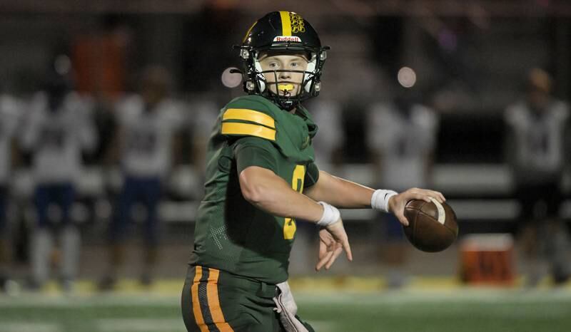Fremd quarterback Johnny O'Brien looks downfield against Hoffman Estates in a football game in Palatine on Friday, Sept. 27, 2024.