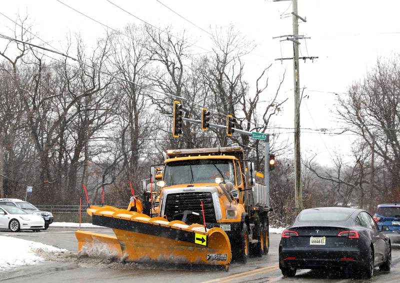 Snow plow trucks travel west on Mooseheart Road in Batavia during a snowstorm on Tuesday, Jan. 9, 2024.