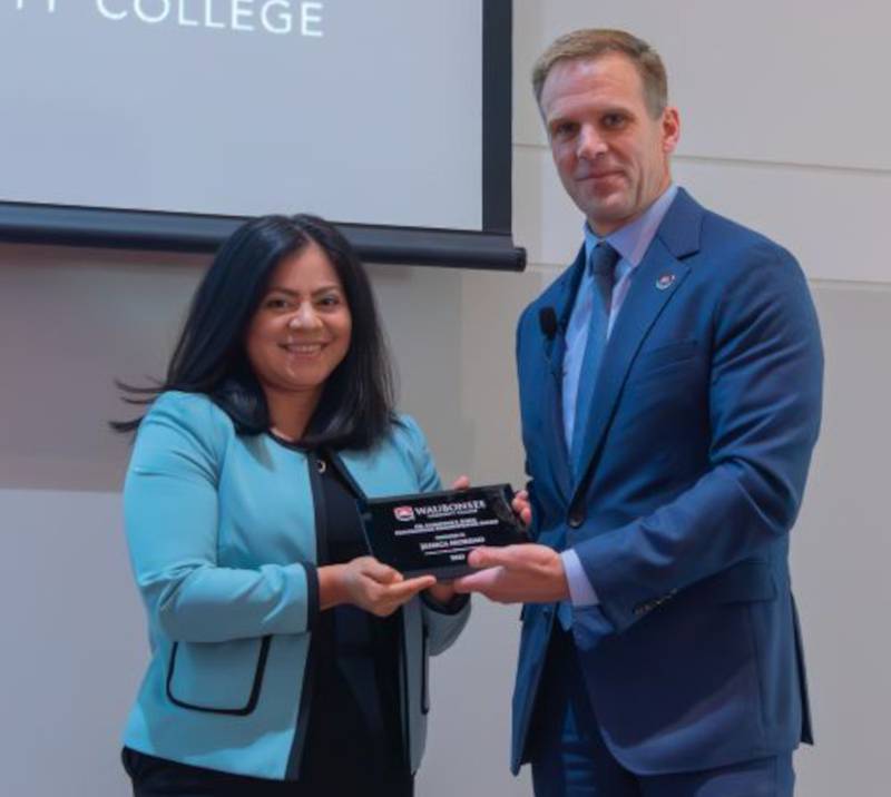 Dr. Brian Knetl, right, president of Waubonsee Community College, presents the Dr. Christine J. Sobek Outstanding Administrator Award to Jessica Moreno, dean for Academic Support.