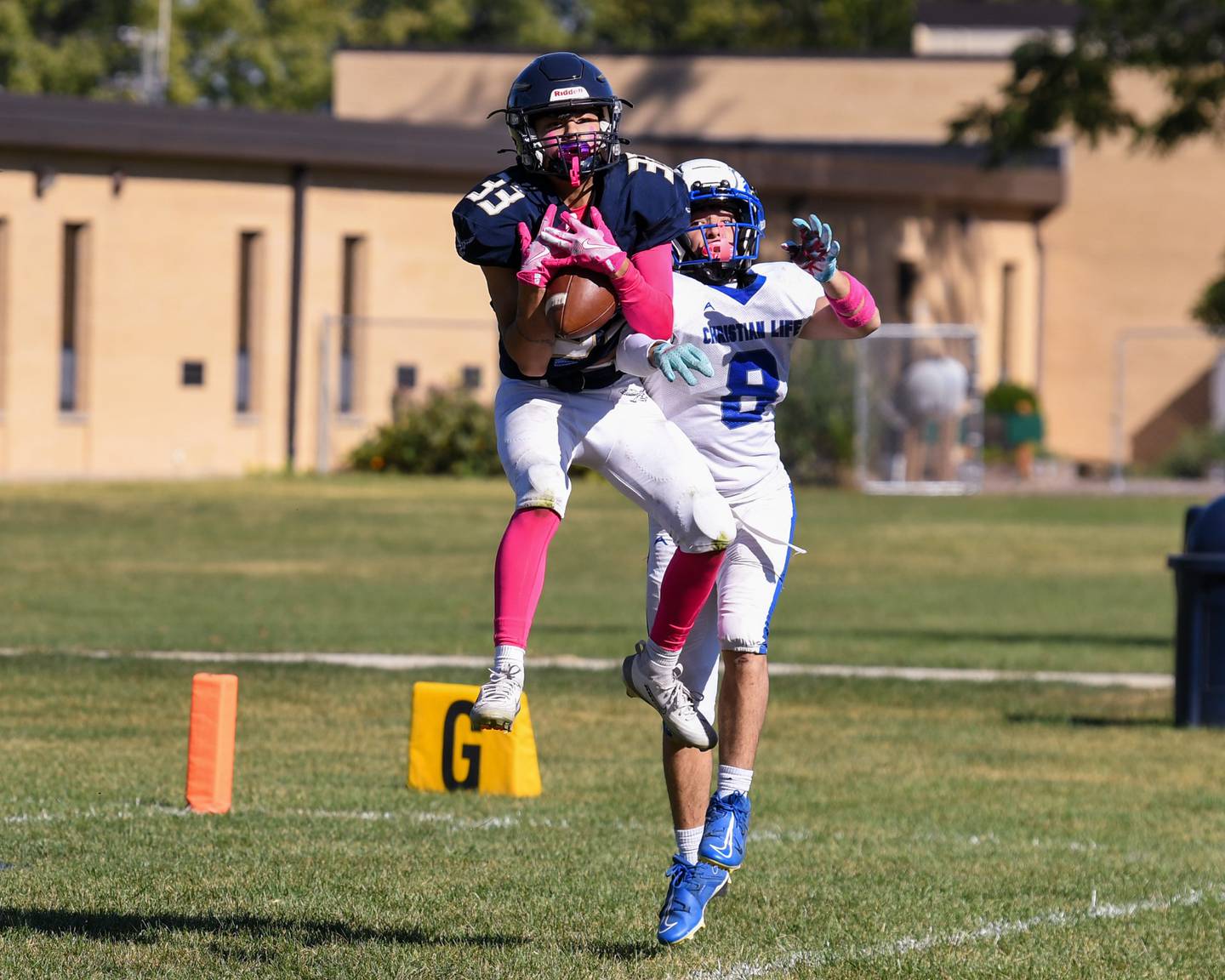 Hiawatha's Isaac Ramangkoun (33) catches the ball while being defended by Rockford Christian Life David Zambraano during the game on Saturday Oct. 11, 2025, held at Hiawatha High School.