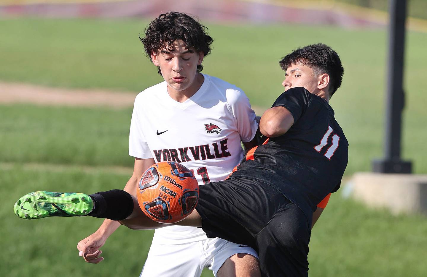Yorkville's Lukas Kleronomos and DeKalb's Kendall Gilkey get tangled up going after a ball during their game Thursday, Aug. 25, 2022, in the Barb Cup at the Northern Illinois University Outdoor Recreation Sports Complex.