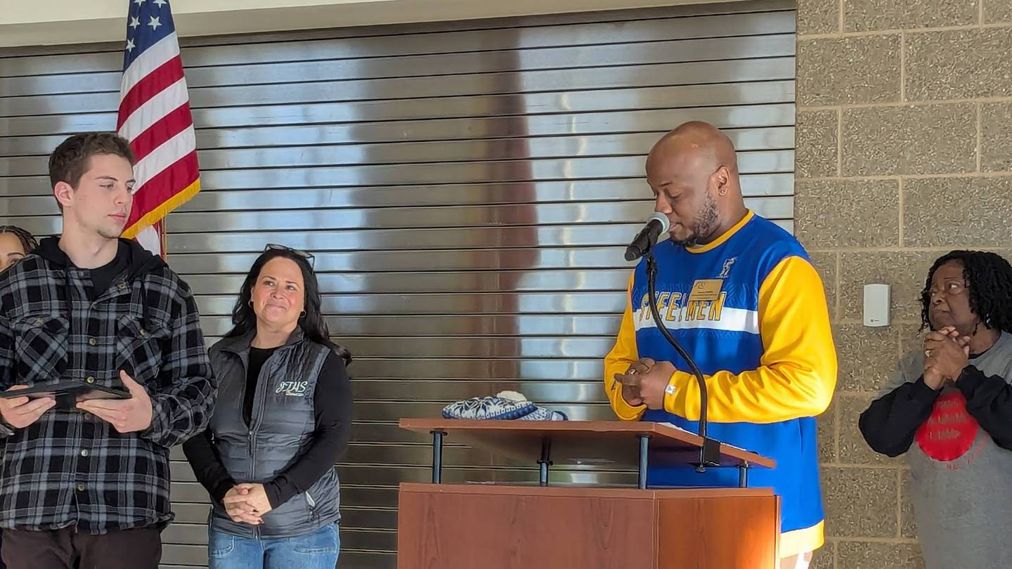 Austin Kittl (left), a student was one of two recipients who received a $1,500 scholarship along with the Michael Austin Clark Community Service Award at the 17th MLK Day of Service on Monday, January 20, 2025, at Joliet Central High School. Naurice Moffatt, a communication specialist for community and alumni outreach at Joliet Township High School District 204 (right), presented the award. Truett Bentsen (not pictured), a student at Joliet Central High School, also received the scholarship and award.