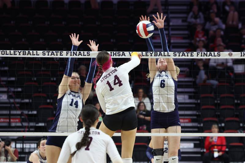 Cissna Park's Marina Day, right, and Annika Stadeli jump to block a hit during the Timberwolves' victory in two sets, 25-11, 25-14, over Stockton in the IHSA Class 1A State championship on Saturday, Nov. 15, 2025.