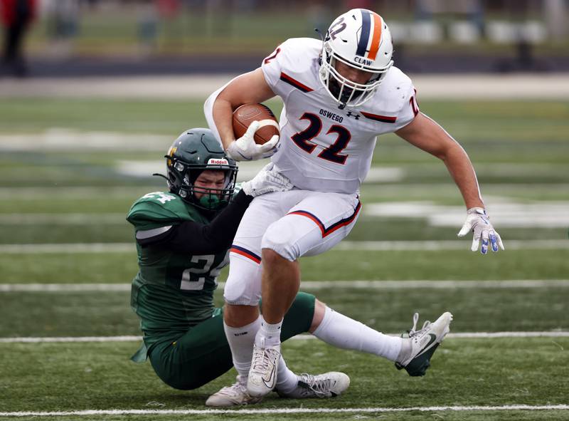 Oswego's Graham Schwab (22) runs the ball during the varsity football second-round 8A playoff game between Oswego and Lane Tech on Saturday, Nov. 8, 2025 in Chicago.