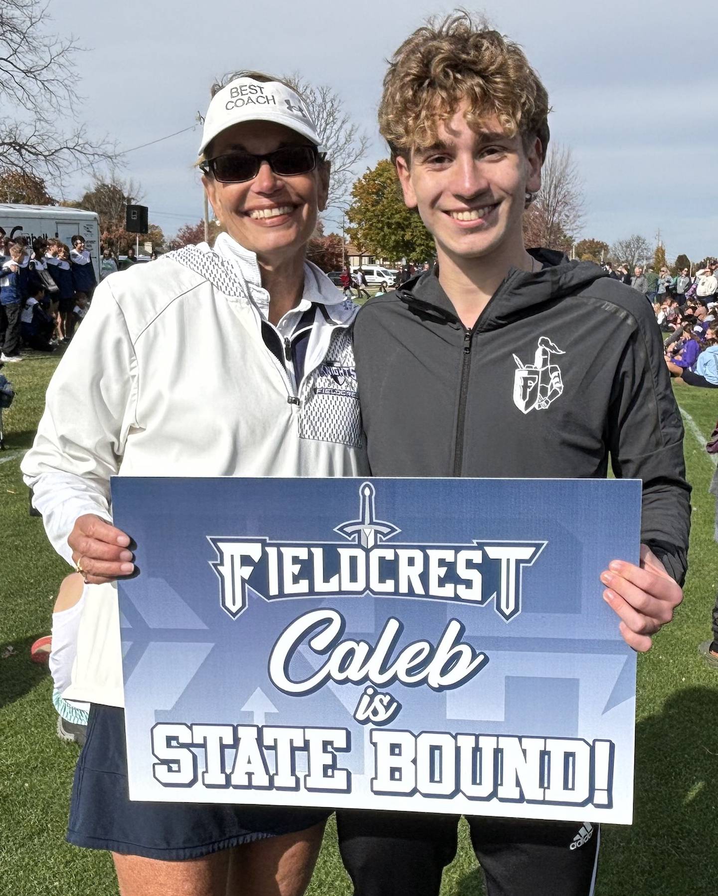 Fieldcrest senior Caleb Krischel (right) poses for a photo with coach Carol Bauer after qualifying for the IHSA Class 1A state cross country meet on Saturday, Nov. 2, 2024 in Rock Island.