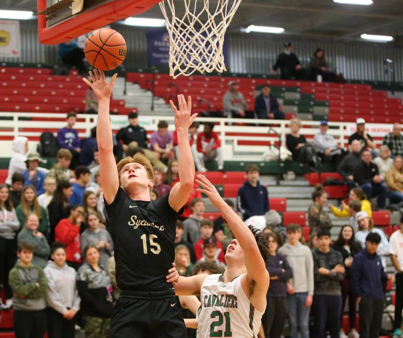Sycamore's Teague Hallahan shoots a shot under the net as L-P's Josh Senica defends on Tuesday, Jan. 31, 2023 at L-P High School.