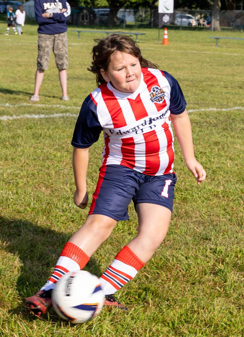 Elyssa Farrell, 8, of Seneca, takes a shot on goal during the shoot out challenge Saturday, Aug. 19, 2023, at Ottawa Youth Soccer Club's opening day festivities.