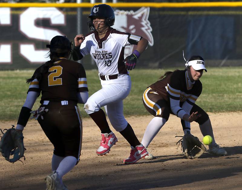 Jacobs' Talia Disilvio (right) fields the ball as Prairie Ridge’s Olivia Swiderek runs to third base during a Fox Valley Conference softball game on April 8, 2026, at Prairie Ridge High School.