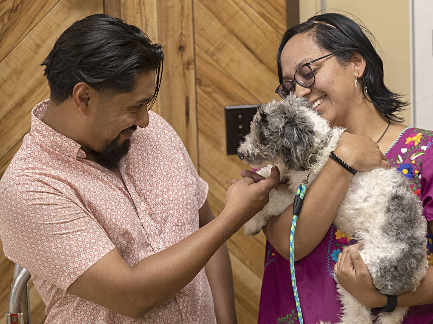 Army veteran David Martinez and Fanny Lopez greet their new therapy dog “Ice” Friday, August 11, 2023 during the adoption in Sterling. Working with 22 Mohawks, a veteran suicide awareness group, Sgt. Floyd Dunn of Sterling helped bring the pup to Martinez.