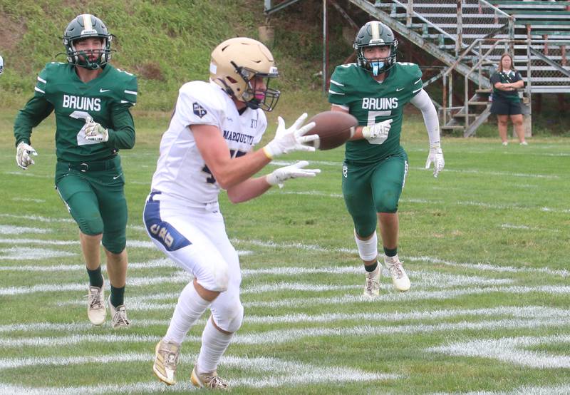 Marquette's Keaton Davis makes a wide-open catch to get a two-point conversion as St. Bede players Carson Riva and Halden Huenburg hustle to the play during the Homecoming game on Saturday, Sept. 28, 2024 at St. Bede Academy.