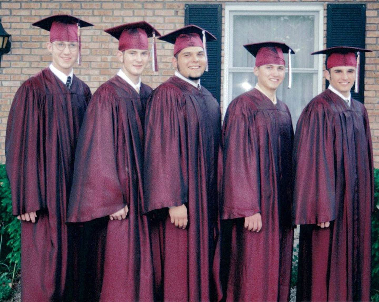 Rob Schwiesow and Nick Wickman pictured with friends at their graduation from Morris Community High School.