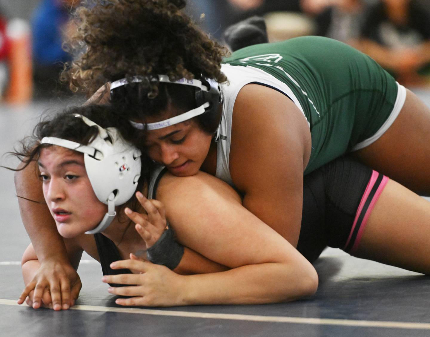 Glenbard West’s Miyalinna DeJesus, top, wrestles West Chicago’s Annette Huesca in the 155-pound championship match of the Willowbrook girls wrestling regional on Saturday, Feb. 1, 2025 in Villa Park.