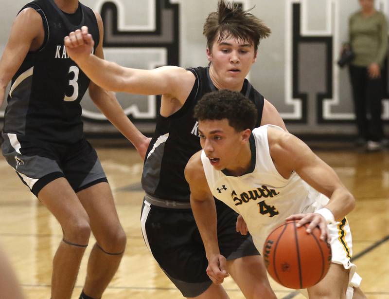 Crystal Lake South's AJ Demirov pushes the ball up the court against Kaneland's Preston Popovich during the IHSA Class 3A Kaneland Boys Basketball Sectional championship game on Friday, March 1, 2024, at Kaneland High School in Maple Park.