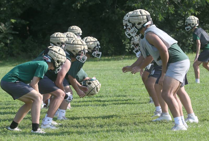 Members of the St. Bede football team run a play during the first day of football practice on Monday, Aug. 11, 2025 at St. Bede Academy.