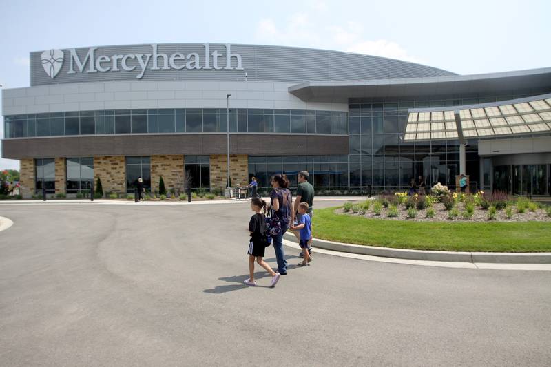 A family strolls the grounds during a public open house for the new Mercyhealth hospital in Crystal Lake on Saturday.