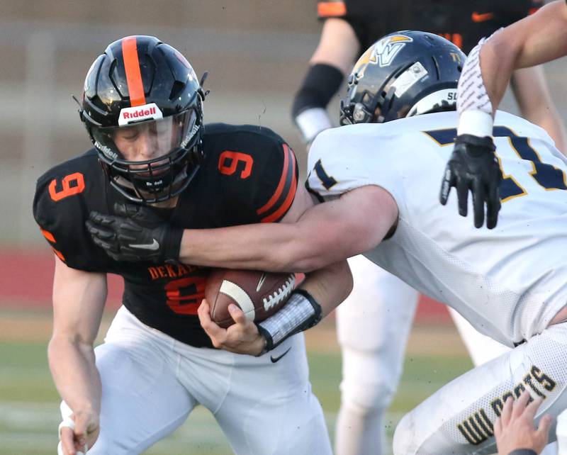 DeKalb running back Tucker Ikens is hit by Nequa Valley's  Daniel Appel during their game Friday, April 16, 2021, at DeKalb High School.