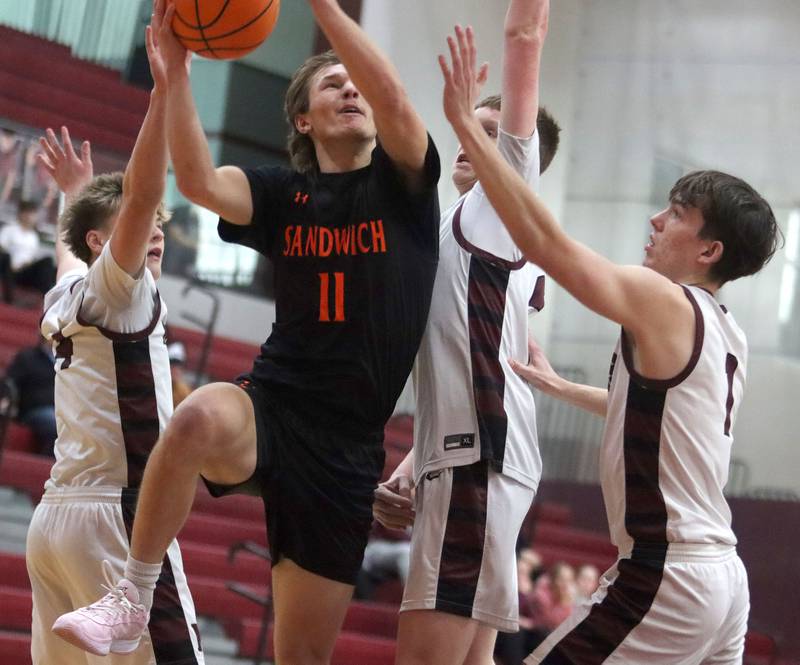 Sandwich’s Nicholas Michalek works under the net in varsity boys basketball action on Saturday, Jan..24, 2025, at Marengo High School in Marengo.