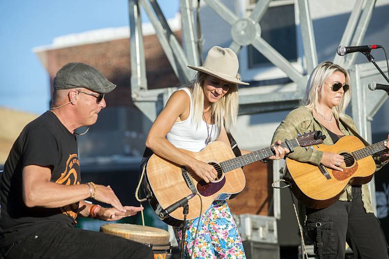 Hometown artist Gina Venier plays with dad Mike during Dixon’s Petunia Fest Friday, July 1, 2022.