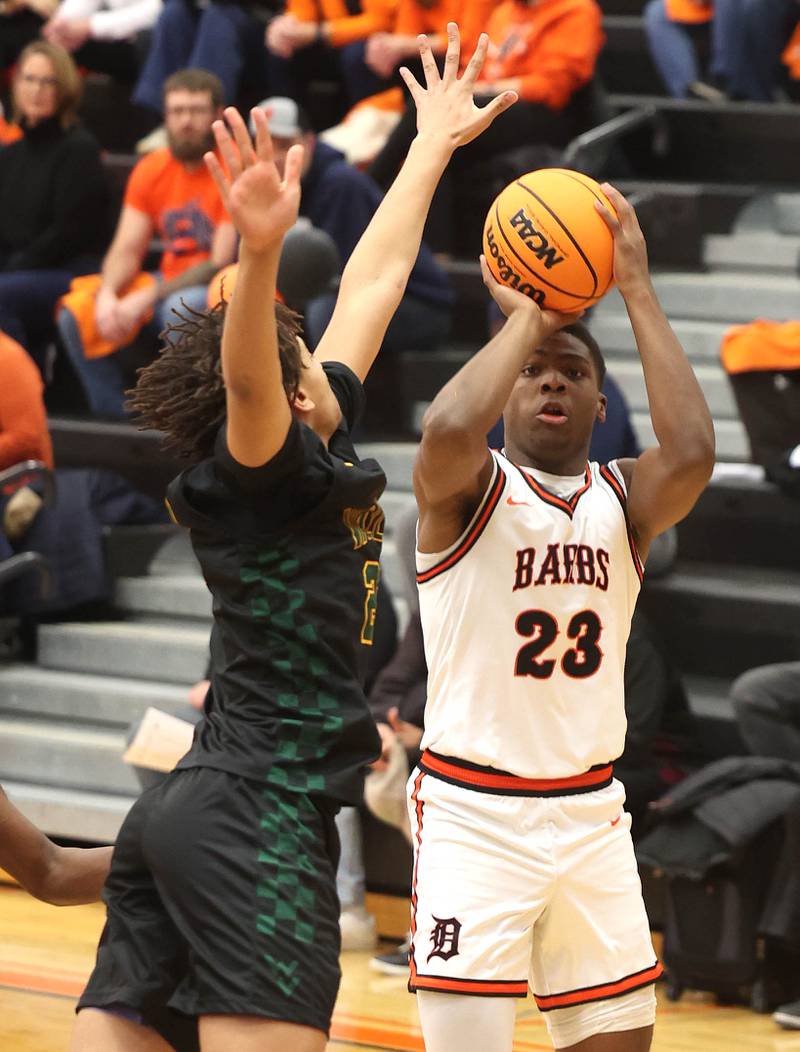 DeKalb's Davon Grant shoots over Waubonsie Valley's Kris Mporokoso during their game Friday, Feb. 21, 2025, at DeKalb High School.