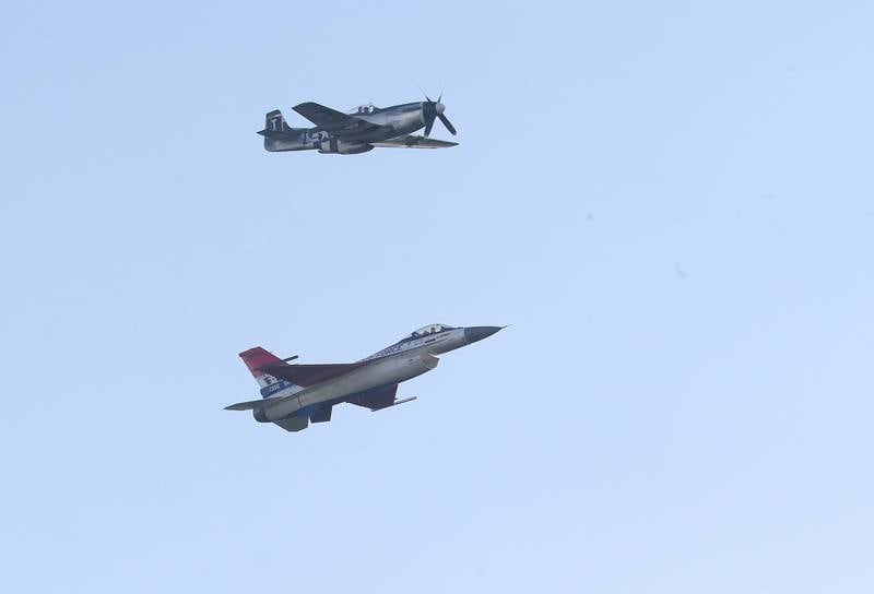 A P-51 Mustang flies next to the Viper F-16 Demo Team aircraft during the 10th annual TBM Avenger Reunion and Airshow on Friday, May 16, 2025 at the Illinois Valley Regional Airport in Peru.
